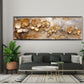 Goldene Orchideen als Panorama-Wandbild über der Couch im Wohnzimmer