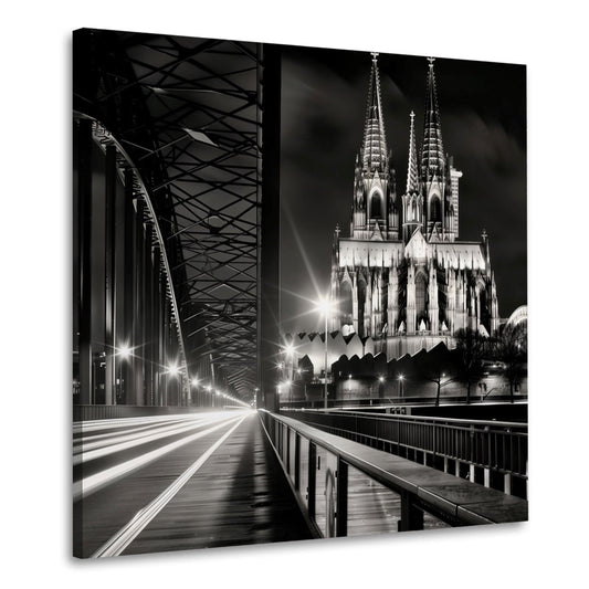 Wandbild Kölner Dom mit Lichtspuren auf der Brücke in Schwarz Weiß
